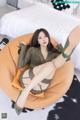 A woman sitting on a bean bag chair in a bedroom.