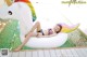 A woman in a bikini laying on an inflatable unicorn.