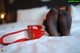 A pair of red shoes sitting on top of a bed.