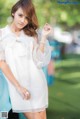 A woman in a white dress posing for a picture.