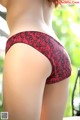 A woman in a red and black lace panties.