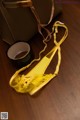 A pair of yellow shoes sitting on top of a wooden table.