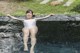 A woman in a white bathing suit sitting in a pool.